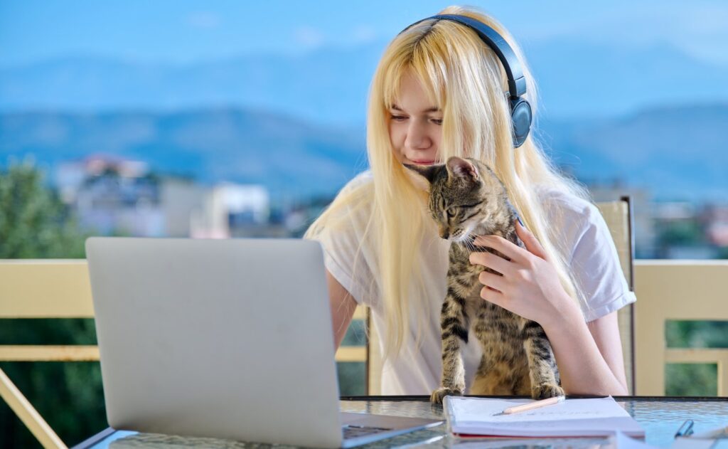 Female student studies at home online using a laptop